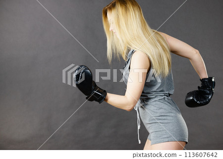 Boxer girl exercise with boxing gloves. 113607642