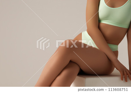 Tanned girl with a perfect body in the studio 113608751