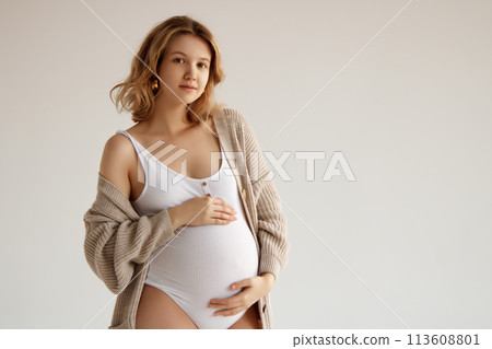 A beautiful pregnant girl in a white bodysuit and A beautiful pregnant girl in a white bodysuit and 113608801