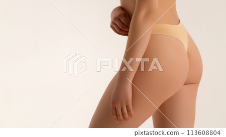 Cropped shot of young slim fit tanned woman with 113608804