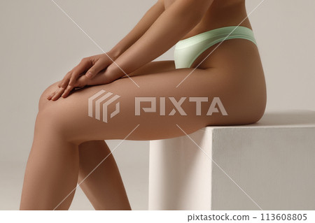 Tanned girl with a perfect body in the studio Tanned girl with a perfect body in the studio 113608805