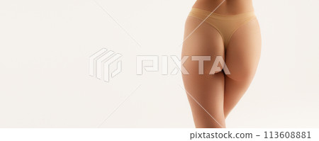 Cropped shot of young slim fit tanned woman with Cropped shot of young slim fit tanned woman with 113608881