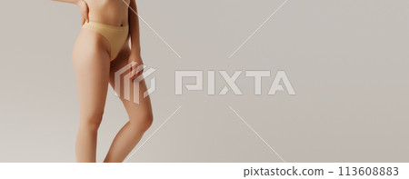 Thin young woman in underwear on beige background Thin young woman in underwear on beige background 113608883