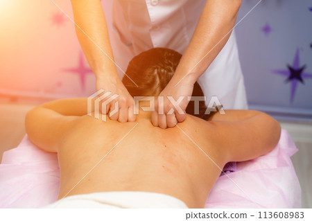 Facial massage. A woman is given a massage in a beauty salon. Close-up. Facial massage. A woman is given a massage in a beauty salon. Close-up. 113608983