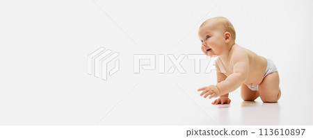 Banner. Charming little baby-girl in diaper crawls against white studio background with negative space to insert text. Banner. Charming little baby-girl in diaper crawls against white studio background with negative space to insert text. 113610897