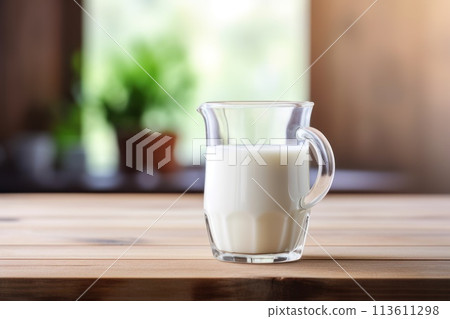 Fresh milk on wooden table top with blur kitchen as background. Space for text or display product. 113611298
