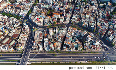 Amazing aerial view by drone of Ho Chi Minh, big Asian city with crowded townhouse, vehicle circulate on street move to intersection, house close together of residence area, cityscape skyline at 113612229