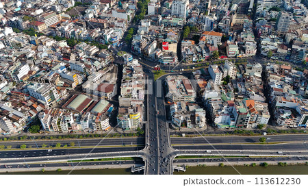 Amazing aerial view by drone of Ho Chi Minh, big Asian city with crowded townhouse, vehicle circulate on street move to intersection, house close together of residence area, cityscape skyline at 113612230