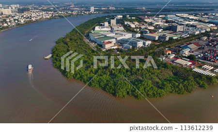 Aerial view from drone of Ho Chi Minh city port, canal system for traffic waterway on Saigon river, crane and container at riverside harbor, logistic for export, import industrial with cheap expense Aerial view from drone of Ho Chi Minh city port, canal system for traffic waterway on Saigon river, crane and container at riverside harbor, logistic for export, import industrial with cheap expense 113612239