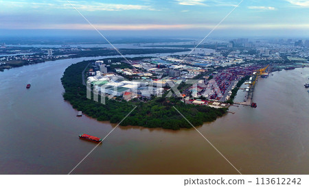 Aerial view from drone of Ho Chi Minh city port, canal system for traffic waterway on Saigon river, crane and container at riverside harbor, logistic for export, import industrial with cheap expense 113612242