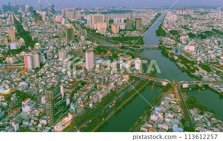 Aerial view from drone of Ho Chi Minh, big Asian city with row of crowded house, Nhieu Loc Thi Nghe canal, Y bridge cross water, vehicle traffic on road, level 4 house slum Aerial view from drone of Ho Chi Minh, big Asian city with row of crowded house, Nhieu Loc Thi Nghe canal, Y bridge cross water, vehicle traffic on road, level 4 house slum 113612257