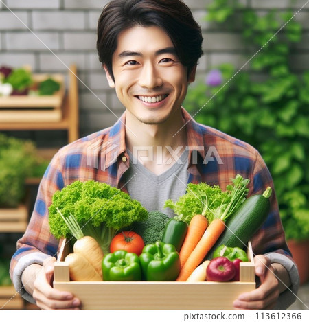 A refreshing young farmer holding a delivery box with a vegetable set 113612366