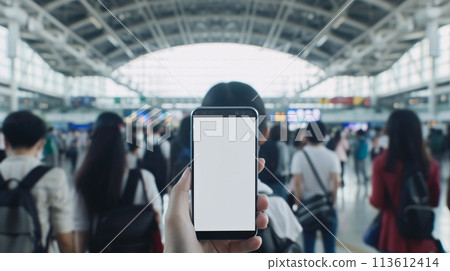 a curious tourist stands clutching a smartphone with a blank, white screen in a foreign city  a curious tourist stands clutching a smartphone with a blank, white screen in a foreign city  113612414