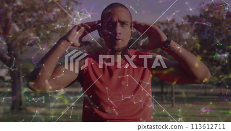 Biracial man wearing headphones outdoors 113612711