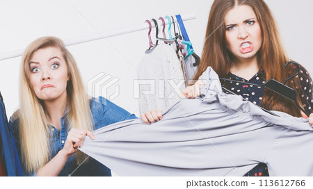 Women arguing during clothes shopping Women arguing during clothes shopping 113612766
