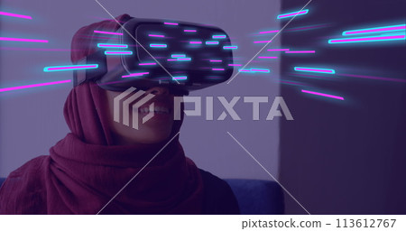 Image of glowing light trails of data transfer over biracial woman in vr headset 113612767
