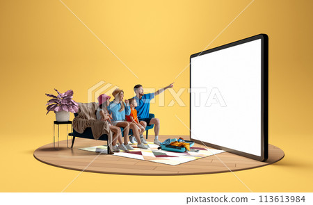Family, man, woman and children sitting on sofa at home and pointing at giant 3D model of tablet, booking hotels and tickets via online services Family, man, woman and children sitting on sofa at home and pointing at giant 3D model of tablet, booking hotels and tickets via online services 113613984