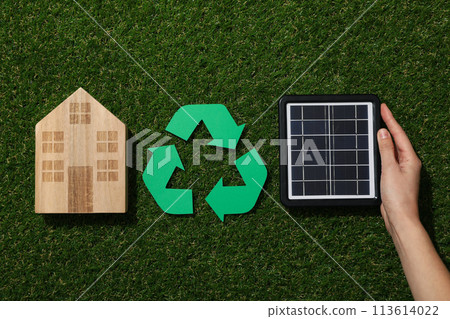 Recycling sign with solar panel on grass 113614022