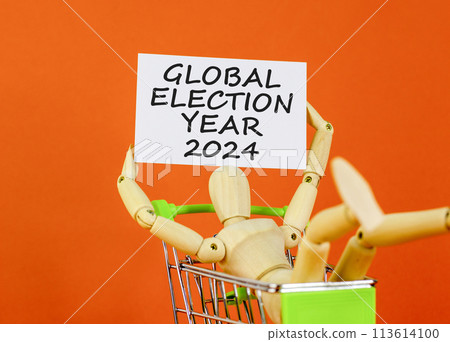 Global election year 2024 symbol. Concept words Global election year 2024 on beautiful white paper. Beautiful orange background. Voter model. Business Global election year 2024 concept. Copy space 113614100