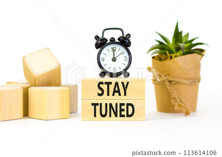 Stay tuned symbol. Concept words Stay tuned on wooden blocks on a beautiful white background. Black alarm clock. Business, support, motivation, psychological and stay tuned concept. Copy space. 113614106