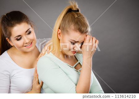 Woman hugging her sad female friend Woman hugging her sad female friend 113614210