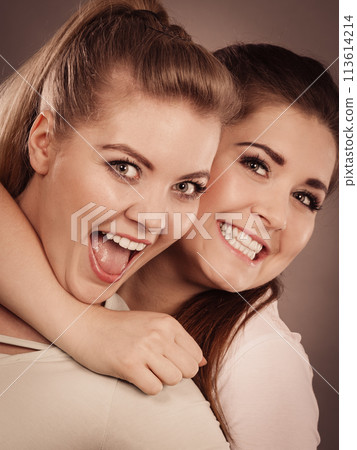 Two happy women friends having fun Two happy women friends having fun 113614214