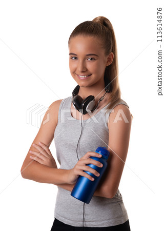 Young sporty young girl in sportswear with headset and water bottle over white background Young sporty young girl in sportswear with headset and water bottle over white background 113614876