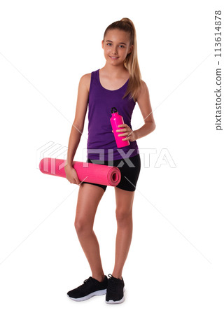 young beautiful slim teen girl holding the yoga mat and water bottle. Full length shot isolated on white background young beautiful slim teen girl holding the yoga mat and water bottle. Full length shot isolated on white background 113614878