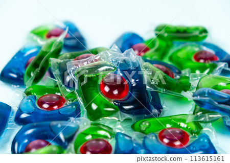 Laundry capsules on blue background close-up 113615161