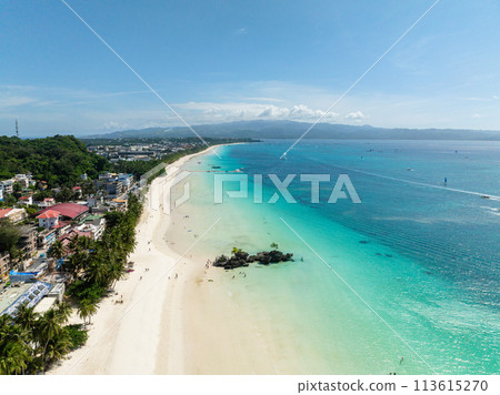 Ocean waves on white sandy beach. Coastal area with coconut trees. Boracay Island. Philippines. Ocean waves on white sandy beach. Coastal area with coconut trees. Boracay Island. Philippines. 113615270
