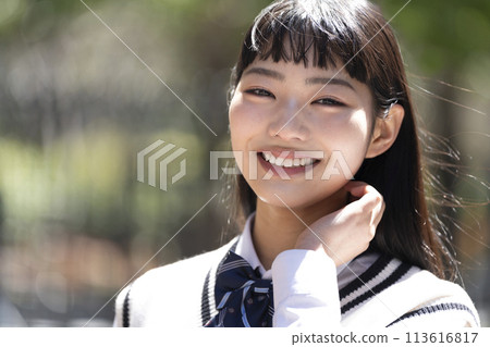 Smiling female high school student looking at camera portrait 113616817