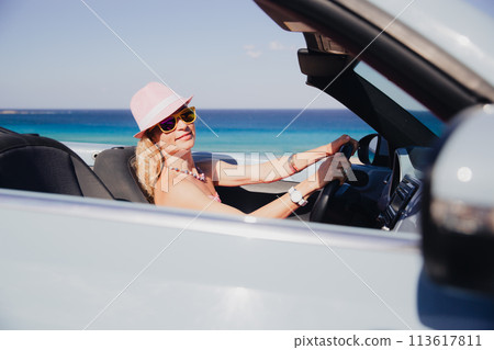 Happy woman travels by car on summer vacation 113617811