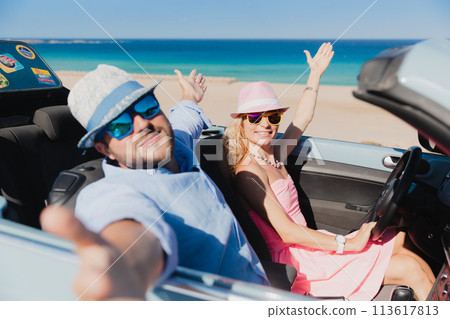 Happy couple travels by car on summer vacation 113617813