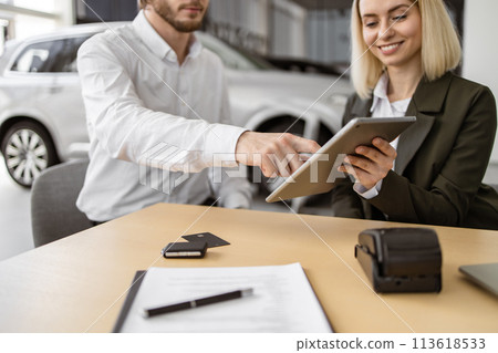 Caucasian rich man customer buyer client in suit sign contract on tablet. Caucasian rich man customer buyer client in suit sign contract on tablet. 113618533