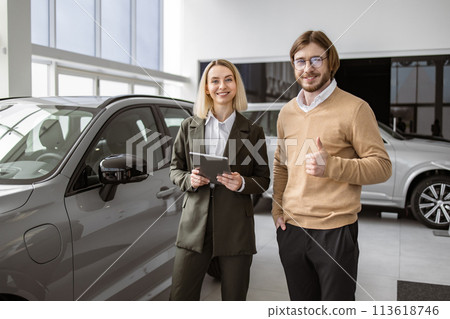 Professional female consultant provides all information about new car to client. Professional female consultant provides all information about new car to client. 113618746