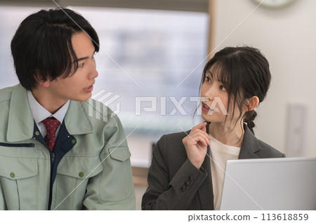 Two male and female engineers having a meeting in an office Two male and female engineers having a meeting in an office 113618859