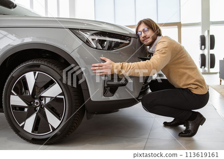 Bearded male buyer rejoices after making his dream come true. Bearded male buyer rejoices after making his dream come true. 113619161