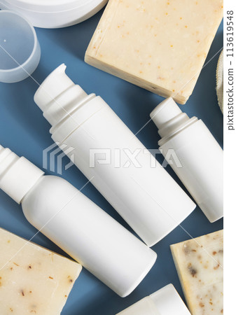 White cosmetic one pump bottles near soap bars on blue in bathroom, mockup White cosmetic one pump bottles near soap bars on blue in bathroom, mockup 113619548