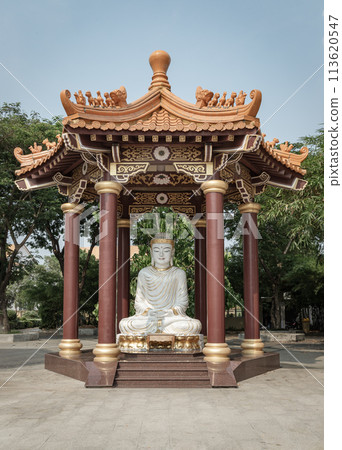 White Jade Gautama Buddha Statue Sitting on Lotus in pavilion. 113620547