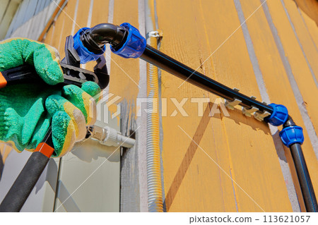 Water pump pliers are used to tighten nut of elbow compression fitting when installing an external water supply for cold drinking water and irrigation. 113621057