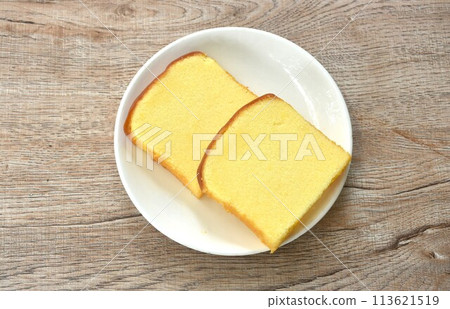 butter vanilla cheesecake cutting in square shape on plate 113621519