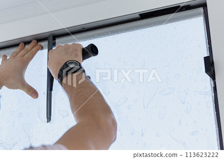 Installation of tinted film. Ultraviolet and energy afficiency concept. 113623222