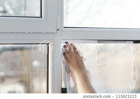 Installation of tinted film. Ultraviolet and energy afficiency concept. 113623223