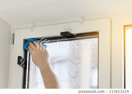 Installation of tinted film. Ultraviolet and energy afficiency concept. 113623224