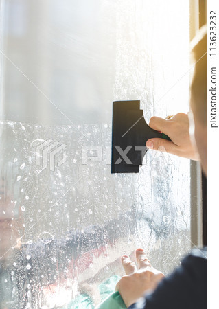 Installation of tinted film. Ultraviolet and energy afficiency concept. 113623232