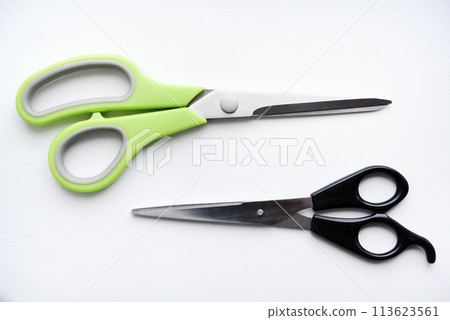 Sewing scissors on a white background. Green scissors. Sewing scissors on a white background. Green scissors. 113623561