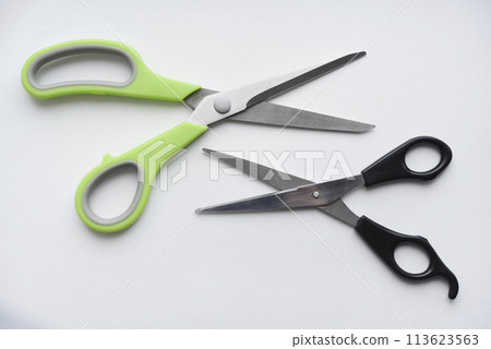 Sewing scissors on a white background. Green scissors. Sewing scissors on a white background. Green scissors. 113623563