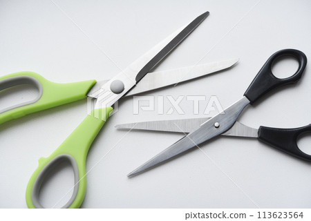 Sewing scissors on a white background. Green scissors. Sewing scissors on a white background. Green scissors. 113623564