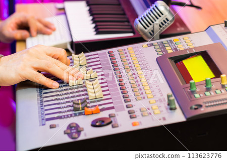 sound engineer, producer hands working on digital audio mixing console in studio. recording, post production, music production concept sound engineer, producer hands working on digital audio mixing console in studio. recording, post production, music production concept 113623776