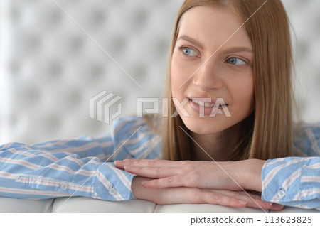 Beauty portrait. Young woman on grey wall background. 113623825